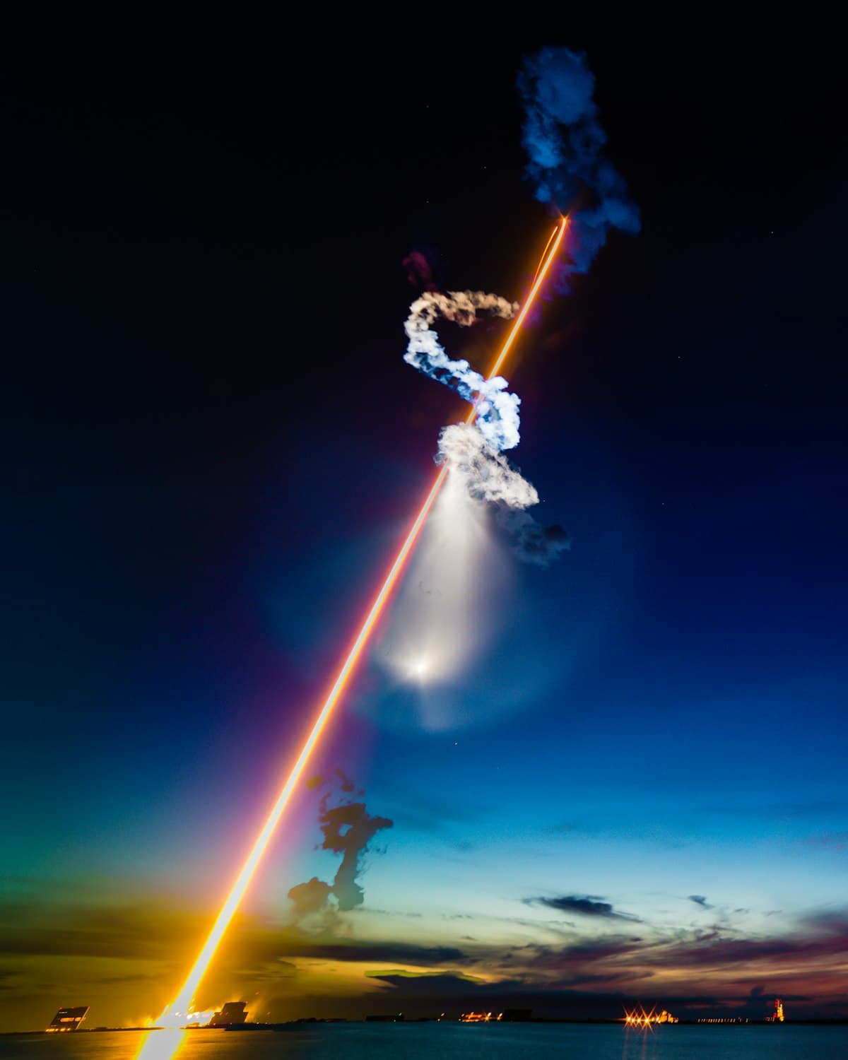 Rocket launching into the night sky, trailing light