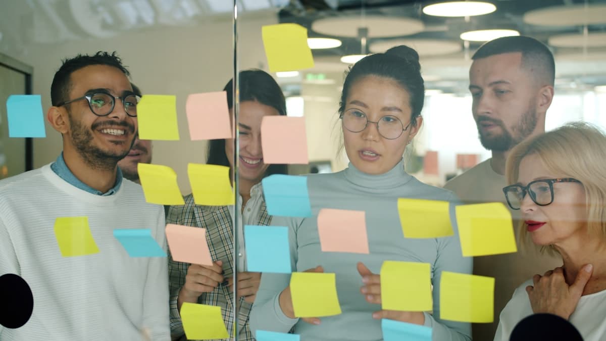 Team reviewing ideas on sticky notes during a discovery workshop